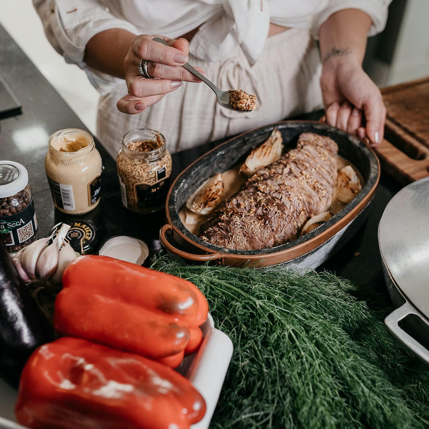 Community members collaborating in a modern kitchen space, sharing recipes and cooking techniques